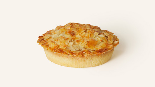 Florentiner-Apfel-Tarte mit knusprigem Mürbeteigboden, zarte Füllung und goldenem Mandel-Nusstopping mit karamellisiertem Glanz und feinen Mandelblättchen bedeckt – ein klassisch-knuspriger Genussmoment aus der Breuninger Confiserie.